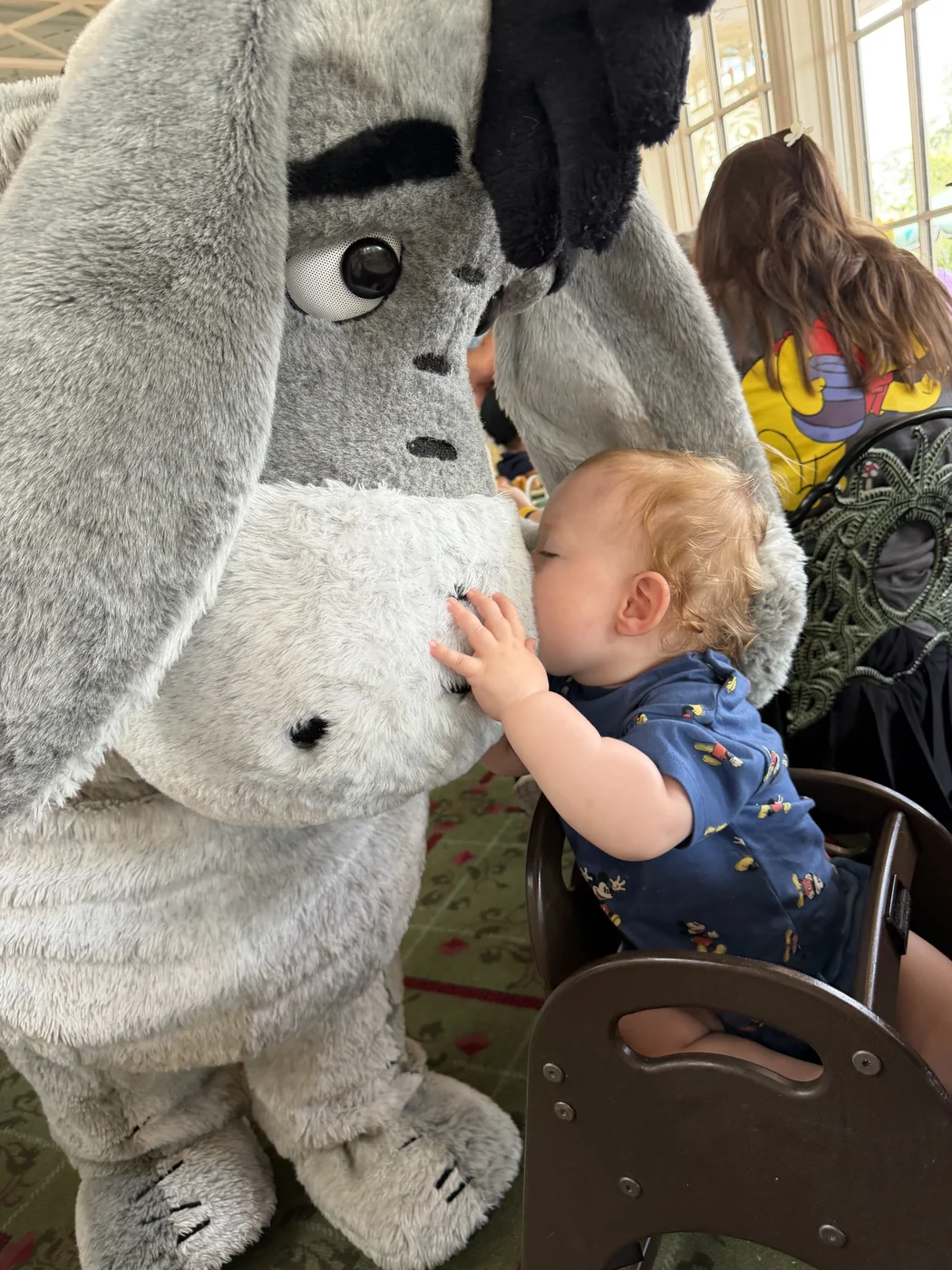 George leaning forward from his high chair to kiss Eeyore’s nose at The Crystal Palace